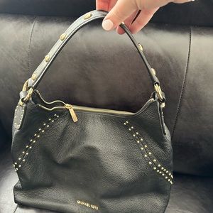 Black Michael Kors shoulder hobo bag with gold embellishments